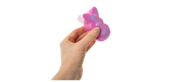 hand holding pink Peeps Scented Bath Bomb on white background